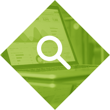 diamond-seo Green diamond-shaped icon with white magnifying glass overlaid on laptop analytics dashboard, representing SEO and data research services